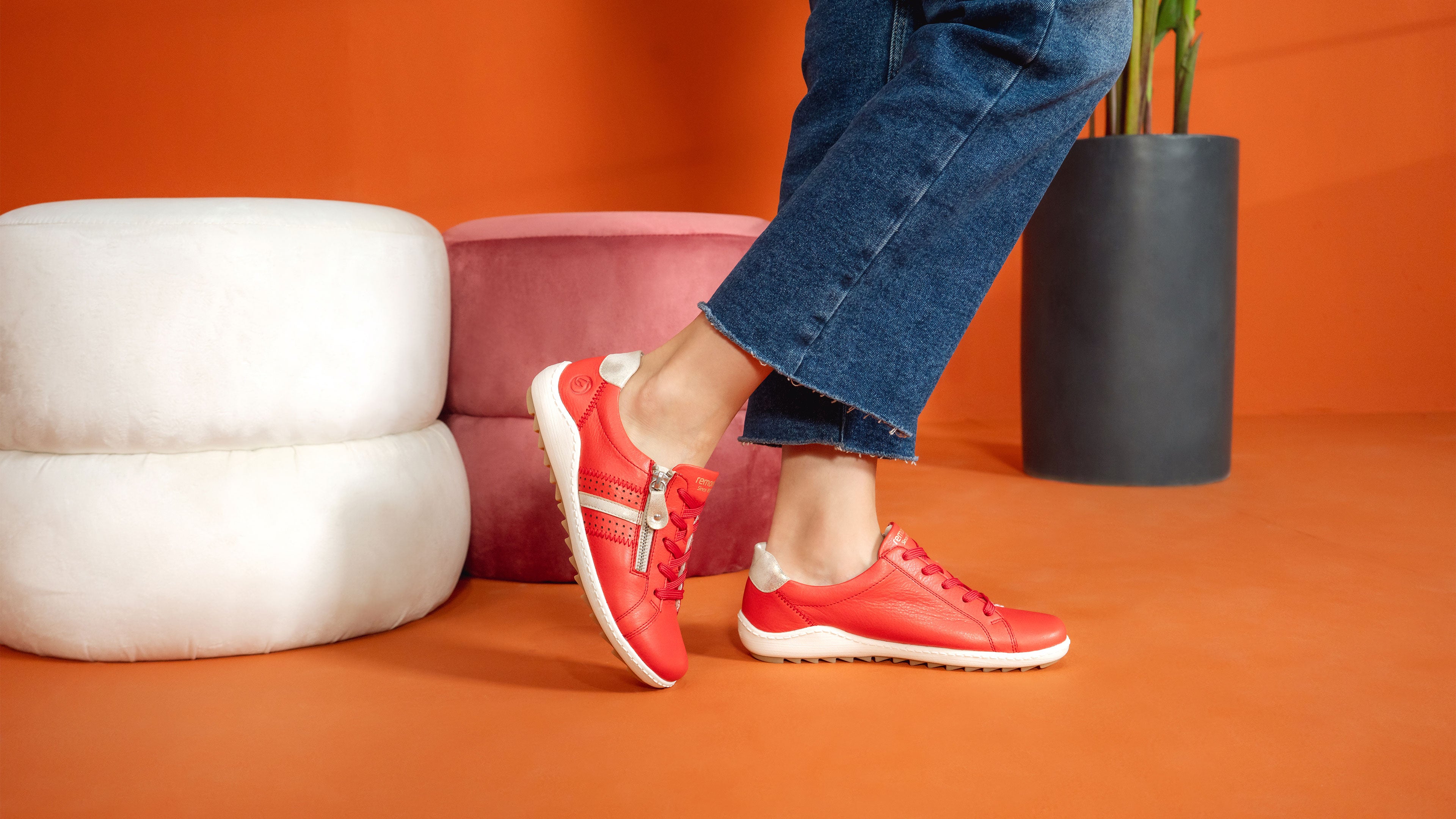 Close-up of a woman wearing red remonte lace-up sneakers