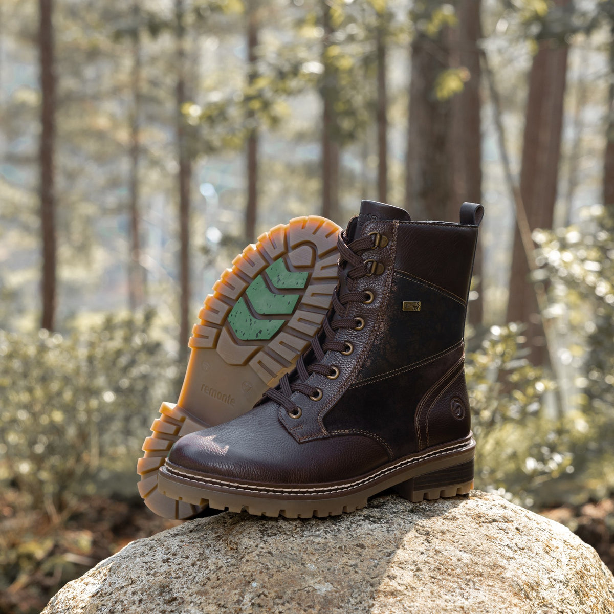 remonte FW26 brown lace-up boots on granite in a pine forest